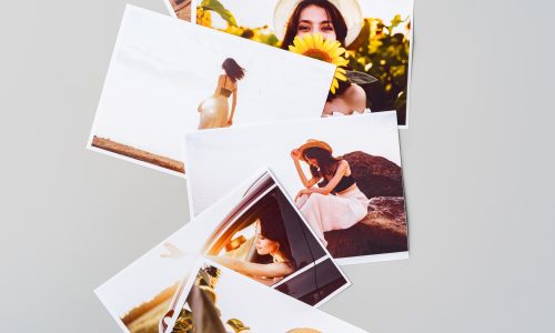 Printed colorful photos of women portraits against gray background